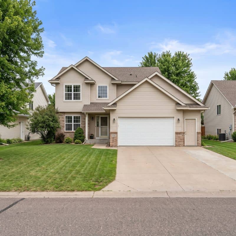 Insulated double garage door on two-story home with brick accents in Princeton, Minnesota